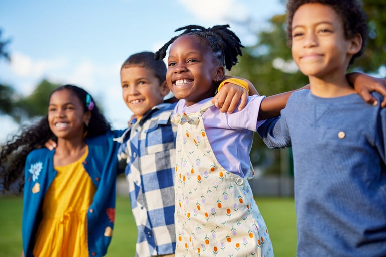 Children jumping together outdoors, having fun at park during summer camp
