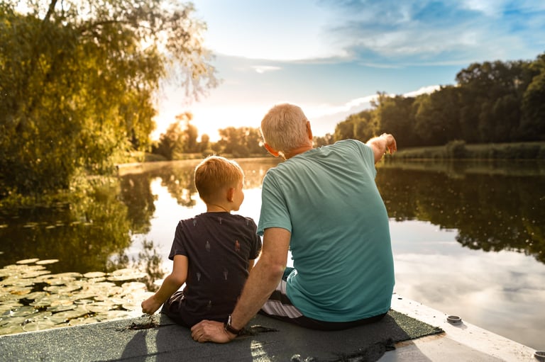 Grandfather and grandson bonding outdoors in peaceful nature
