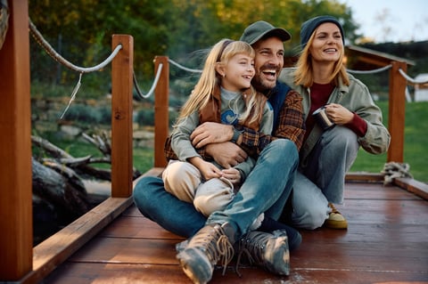 Happy family enjoying while relaxing on a pier in nature